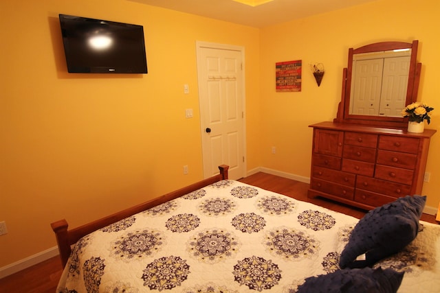 bedroom with dark hardwood / wood-style flooring