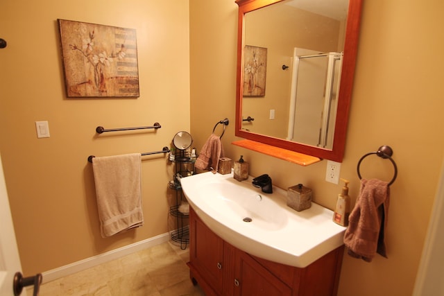 bathroom with vanity and a shower with door