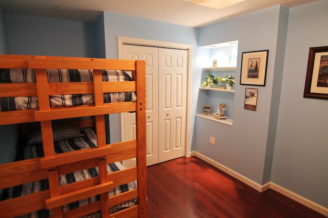 bedroom featuring a closet and dark hardwood / wood-style floors