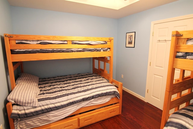 bedroom with dark hardwood / wood-style floors