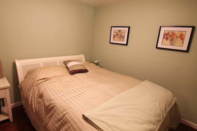 bedroom featuring dark hardwood / wood-style flooring