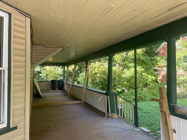 unfurnished sunroom with wooden ceiling and plenty of natural light