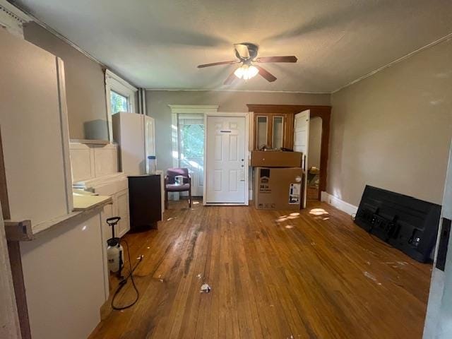 interior space with wood-type flooring and ceiling fan