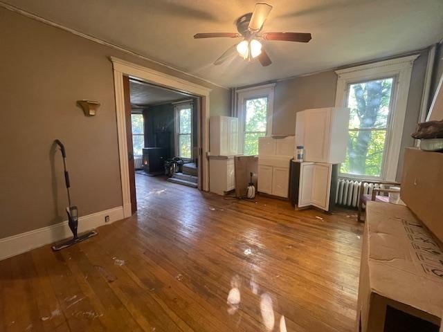 interior space featuring radiator, ceiling fan, and hardwood / wood-style flooring