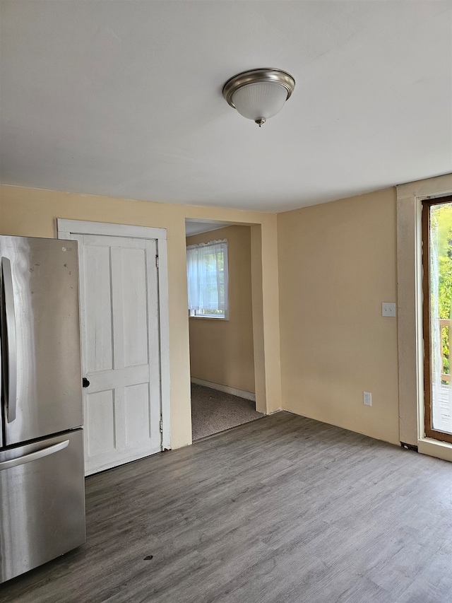 interior space with hardwood / wood-style flooring and stainless steel refrigerator