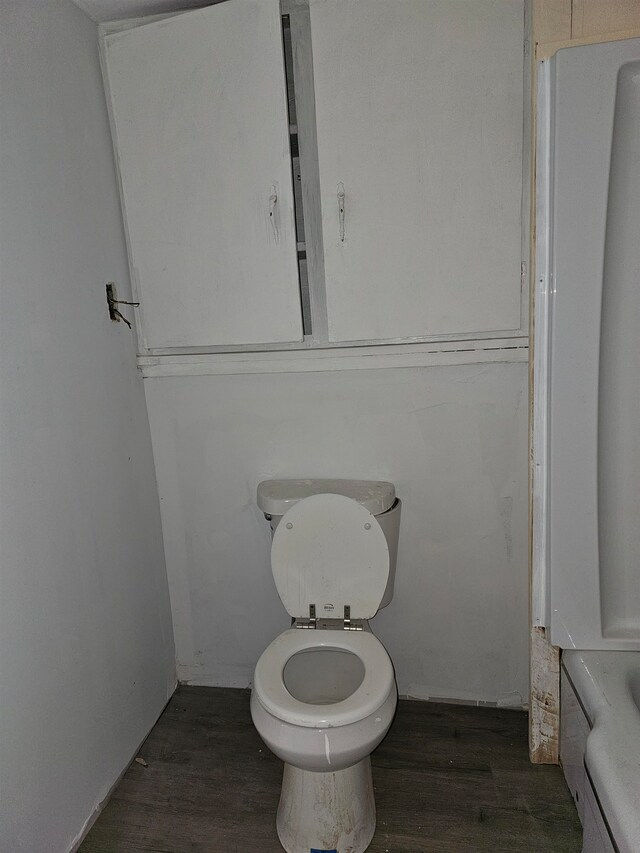 bathroom featuring hardwood / wood-style flooring and toilet