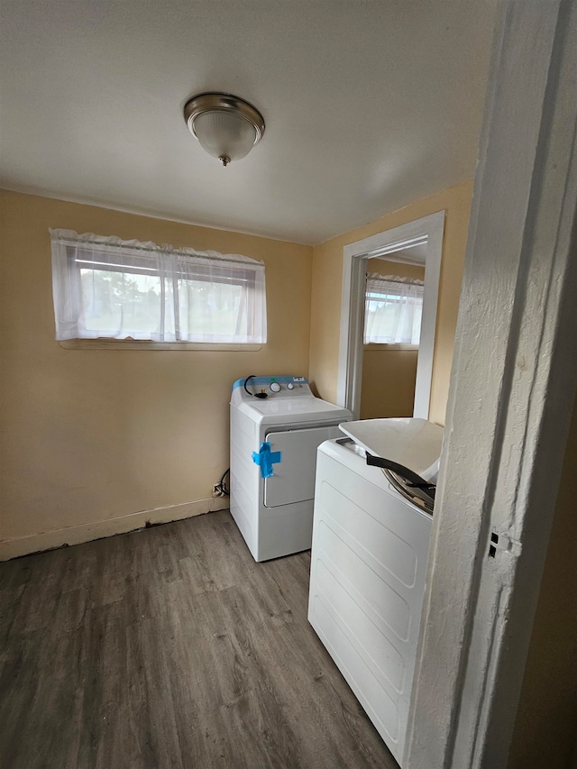 washroom featuring hardwood / wood-style flooring, washer / clothes dryer, and a wealth of natural light