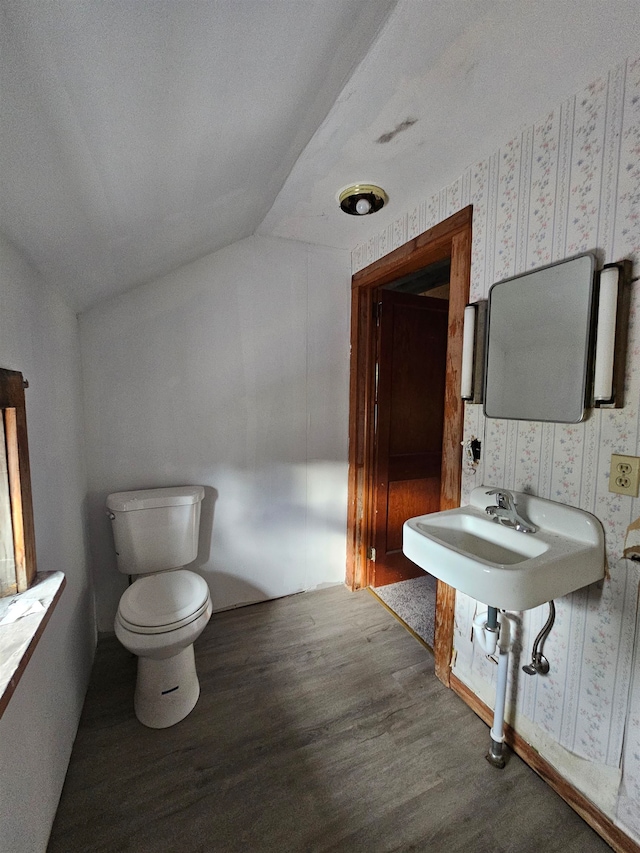 bathroom featuring a textured ceiling, lofted ceiling, toilet, and hardwood / wood-style flooring