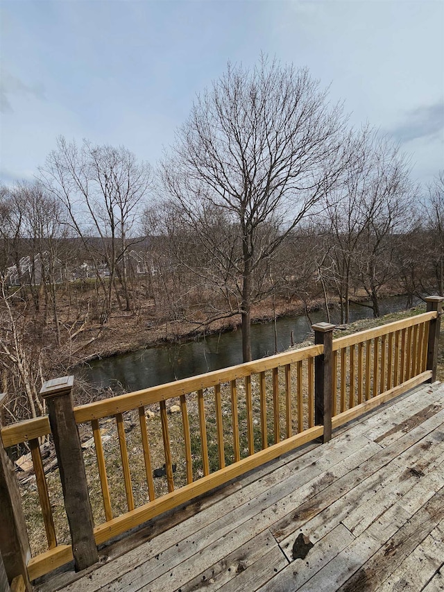 wooden terrace featuring a water view