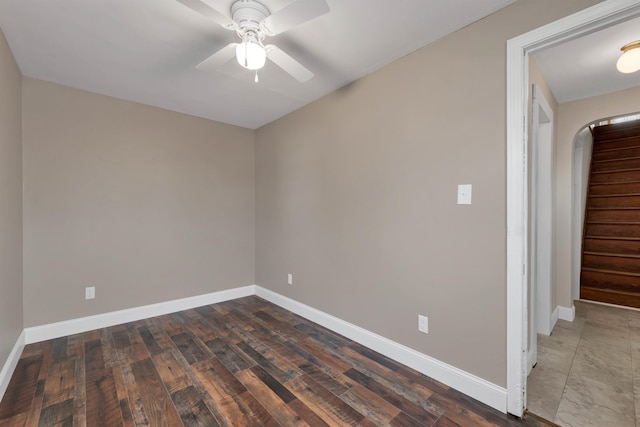 empty room with ceiling fan and dark wood-type flooring