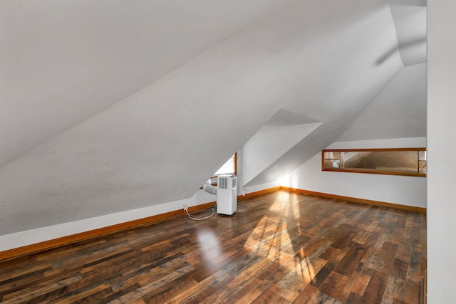 bonus room with lofted ceiling and dark hardwood / wood-style floors