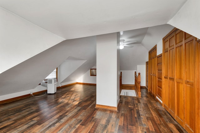 additional living space with ceiling fan, lofted ceiling, and dark hardwood / wood-style floors