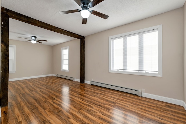 unfurnished room with ceiling fan, a textured ceiling, baseboard heating, and dark hardwood / wood-style flooring