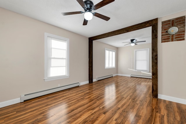 empty room with a baseboard heating unit, ceiling fan, and dark hardwood / wood-style flooring