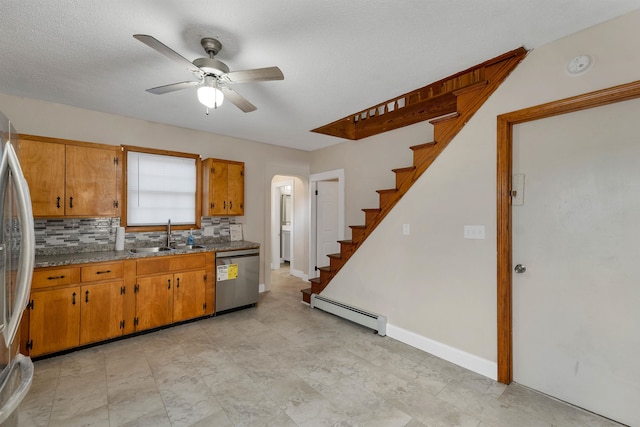 kitchen with tasteful backsplash, stainless steel appliances, ceiling fan, a baseboard radiator, and sink