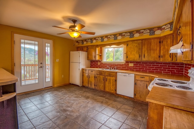 kitchen with under cabinet range hood, white appliances, ceiling fan, and brown cabinetry