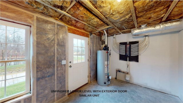 basement with gas water heater and a healthy amount of sunlight