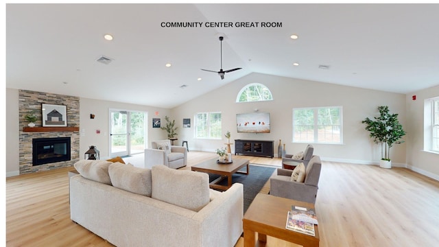 living room featuring a healthy amount of sunlight, a stone fireplace, and ceiling fan