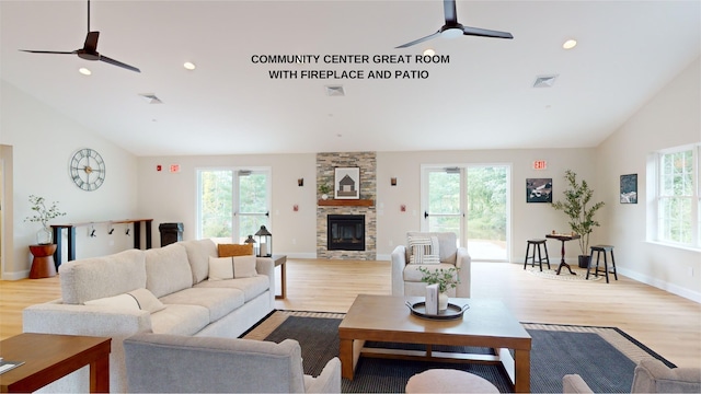 living room featuring light wood-type flooring, ceiling fan, plenty of natural light, and a fireplace