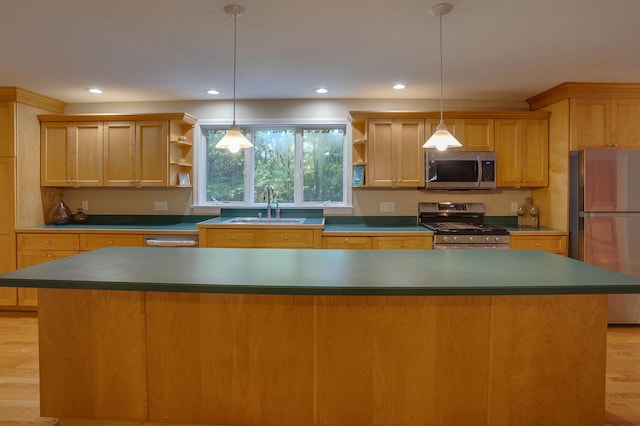 kitchen with hanging light fixtures, sink, light hardwood / wood-style flooring, appliances with stainless steel finishes, and a center island