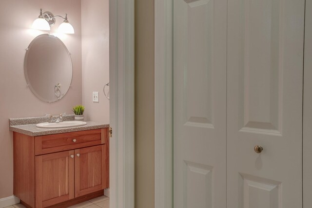 bathroom with tile patterned flooring and vanity