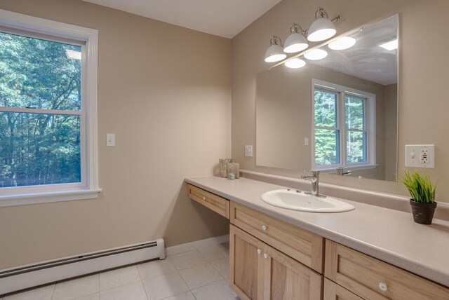 bathroom featuring a baseboard radiator, tile patterned floors, a healthy amount of sunlight, and vanity