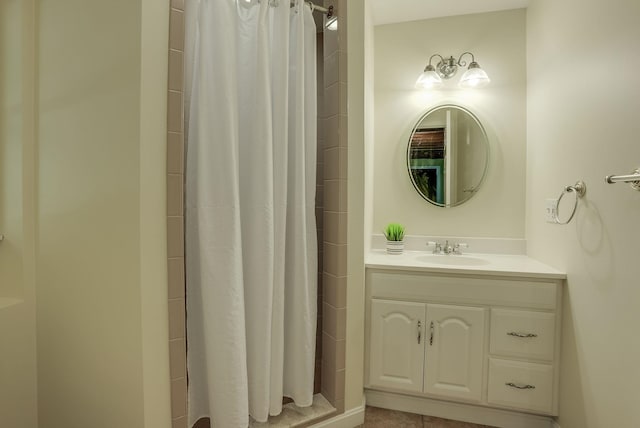 bathroom featuring walk in shower and vanity