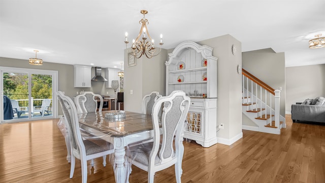 dining space with a chandelier and light hardwood / wood-style floors