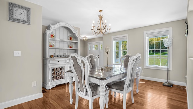 dining area featuring an inviting chandelier and wood-type flooring