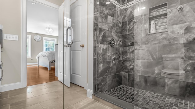 bathroom with hardwood / wood-style flooring and tiled shower