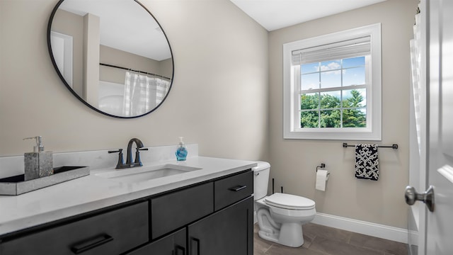 bathroom with vanity, tile patterned flooring, and toilet