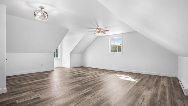 additional living space with vaulted ceiling, ceiling fan, and dark hardwood / wood-style flooring