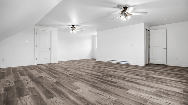 interior space with vaulted ceiling, baseboard heating, ceiling fan, and dark hardwood / wood-style flooring