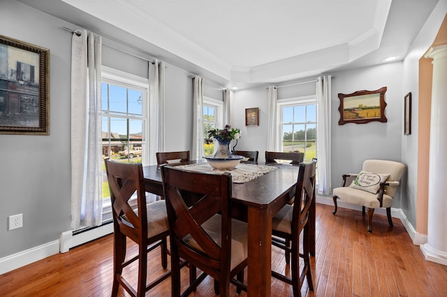 dining room with light hardwood / wood-style flooring, plenty of natural light, ornate columns, and crown molding