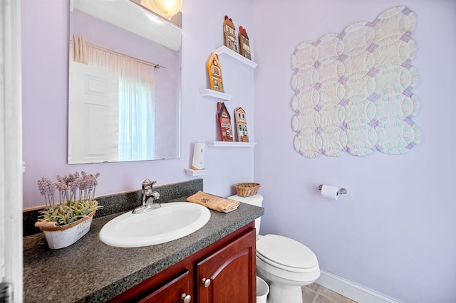 bathroom with vanity, toilet, and tile patterned floors