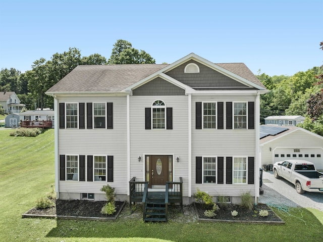 colonial inspired home with a front lawn