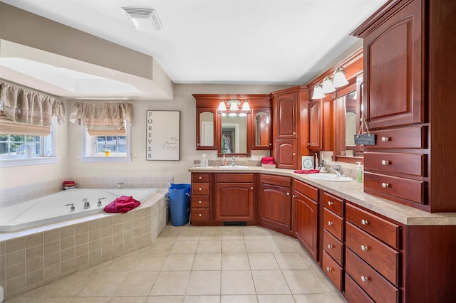 bathroom featuring a relaxing tiled tub, tile patterned flooring, and vanity