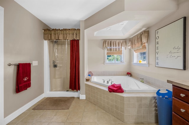 bathroom with tile patterned flooring, vanity, and plus walk in shower