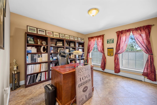 office featuring plenty of natural light, light tile patterned floors, and a baseboard heating unit