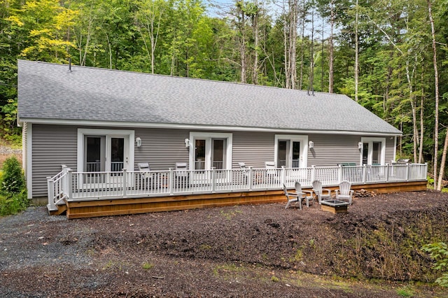 back of house featuring french doors and a wooden deck