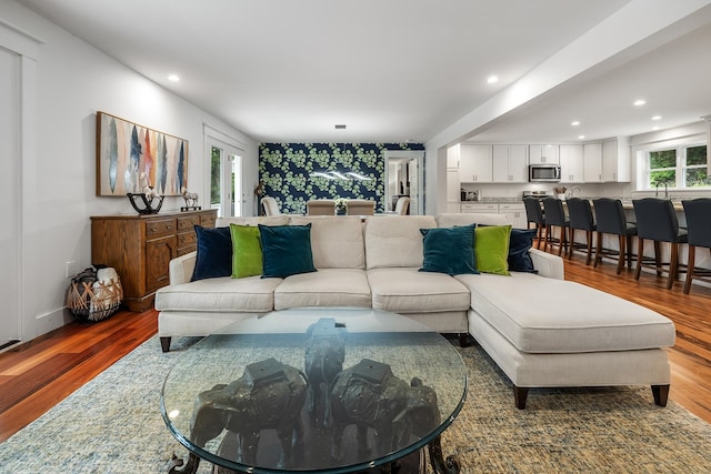 living room featuring hardwood / wood-style flooring and sink