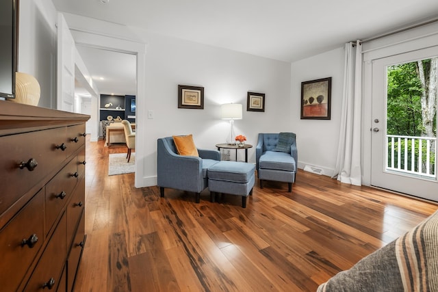 sitting room with wood-type flooring