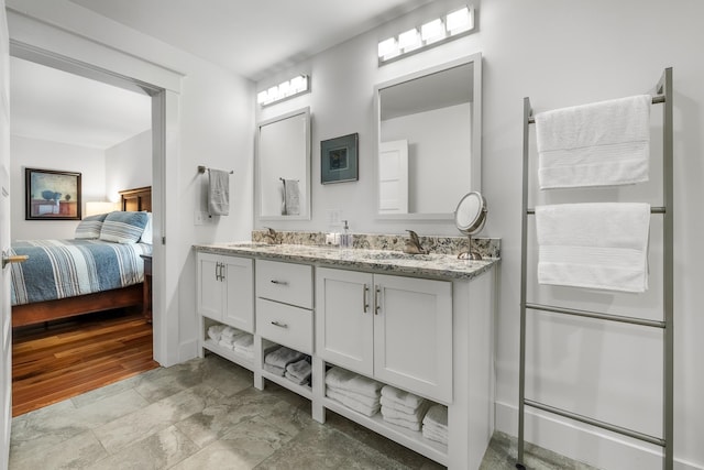 bathroom featuring wood-type flooring, vanity, and a shower with shower door