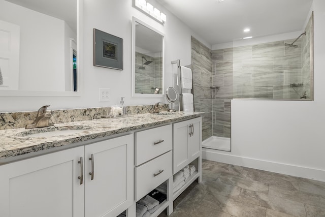 bathroom featuring a tile shower and vanity