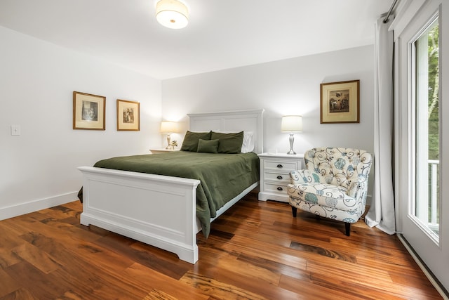 bedroom with dark hardwood / wood-style flooring