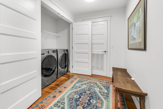 clothes washing area with light wood-type flooring and washing machine and clothes dryer