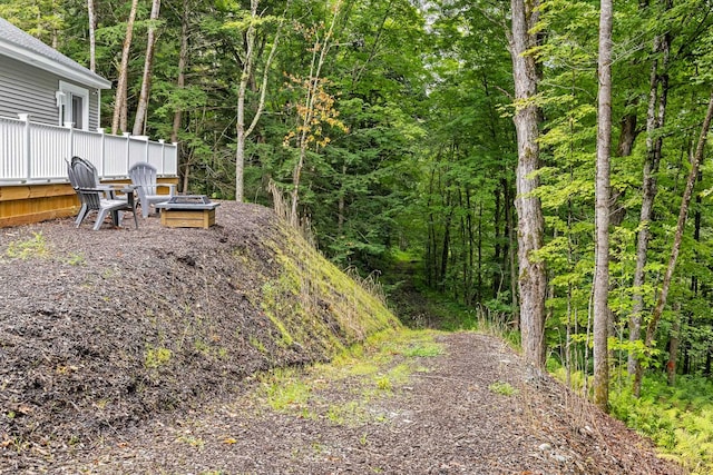 view of yard featuring a deck and a fire pit