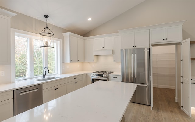 kitchen featuring stainless steel appliances, white cabinetry, and sink