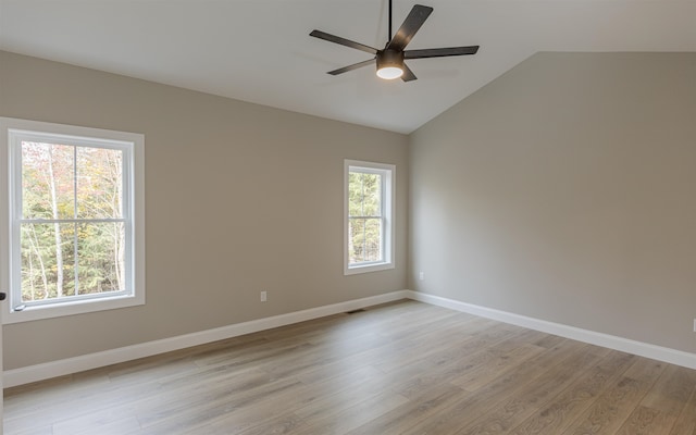 empty room featuring ceiling fan, lofted ceiling, and light hardwood / wood-style floors