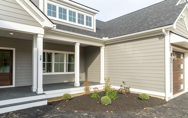 view of exterior entry featuring a porch